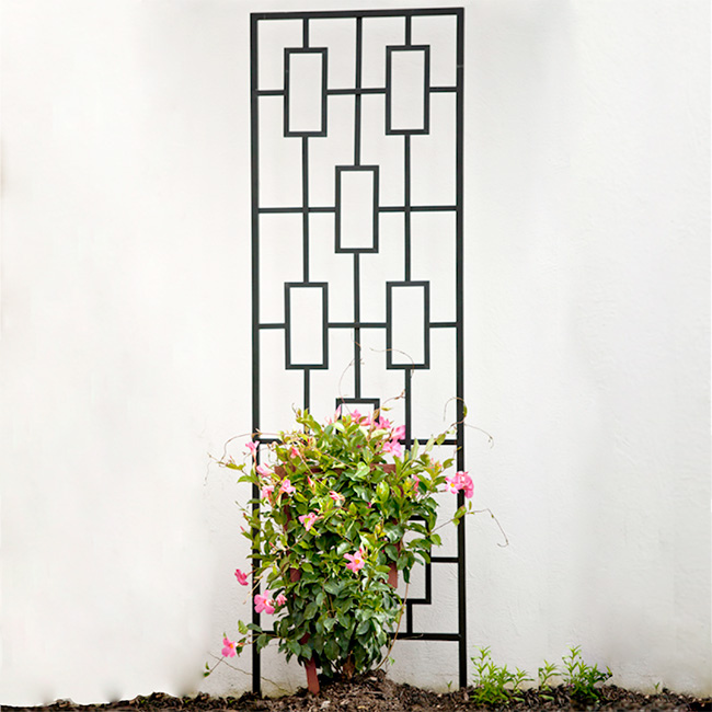 The Contemporary Plant Climber Trellis standing tall in a garden, offering a geometric frame and a secure base for climbing vines.